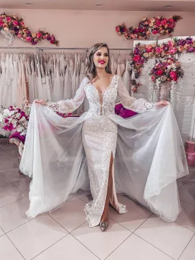 ---Very special and sensual wedding dress with detachable tulle train, deep V neckline and long sleeves decorated with sequins a